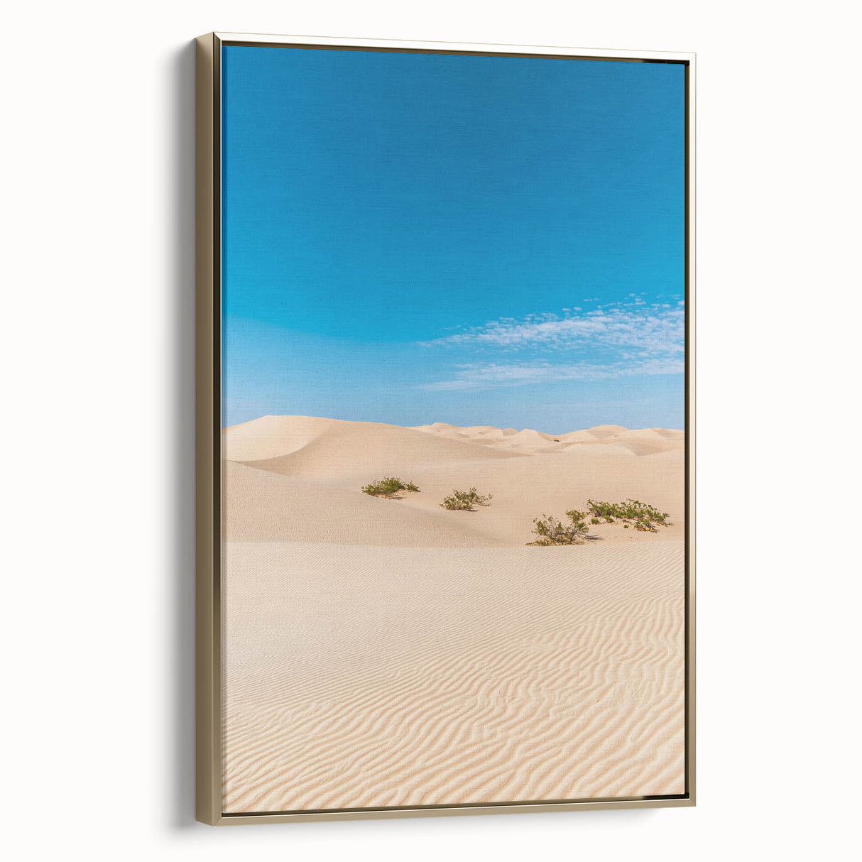 Framed canvas artwork showcasing a serene desert landscape with soft golden dunes, elegantly displayed from the side, ideal for modern home decor.