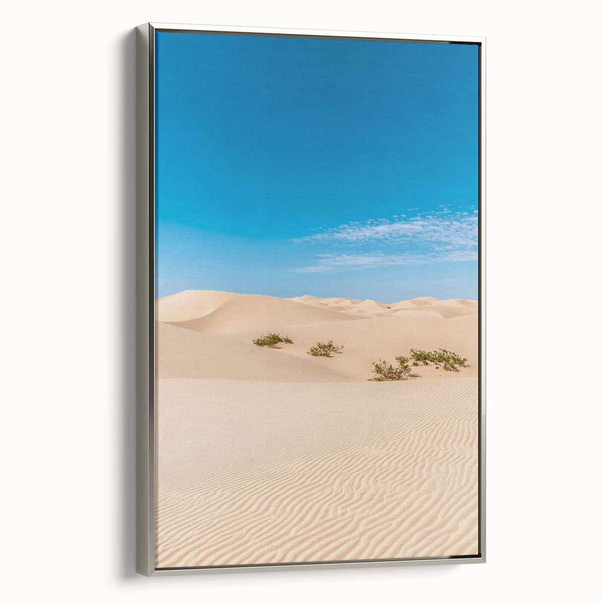 Framed canvas artwork depicting serene sand dunes in a landscape design, featuring a sleek silver frame and showcasing soft earth tones for a calming aesthetic. Ideal for modern home decor.