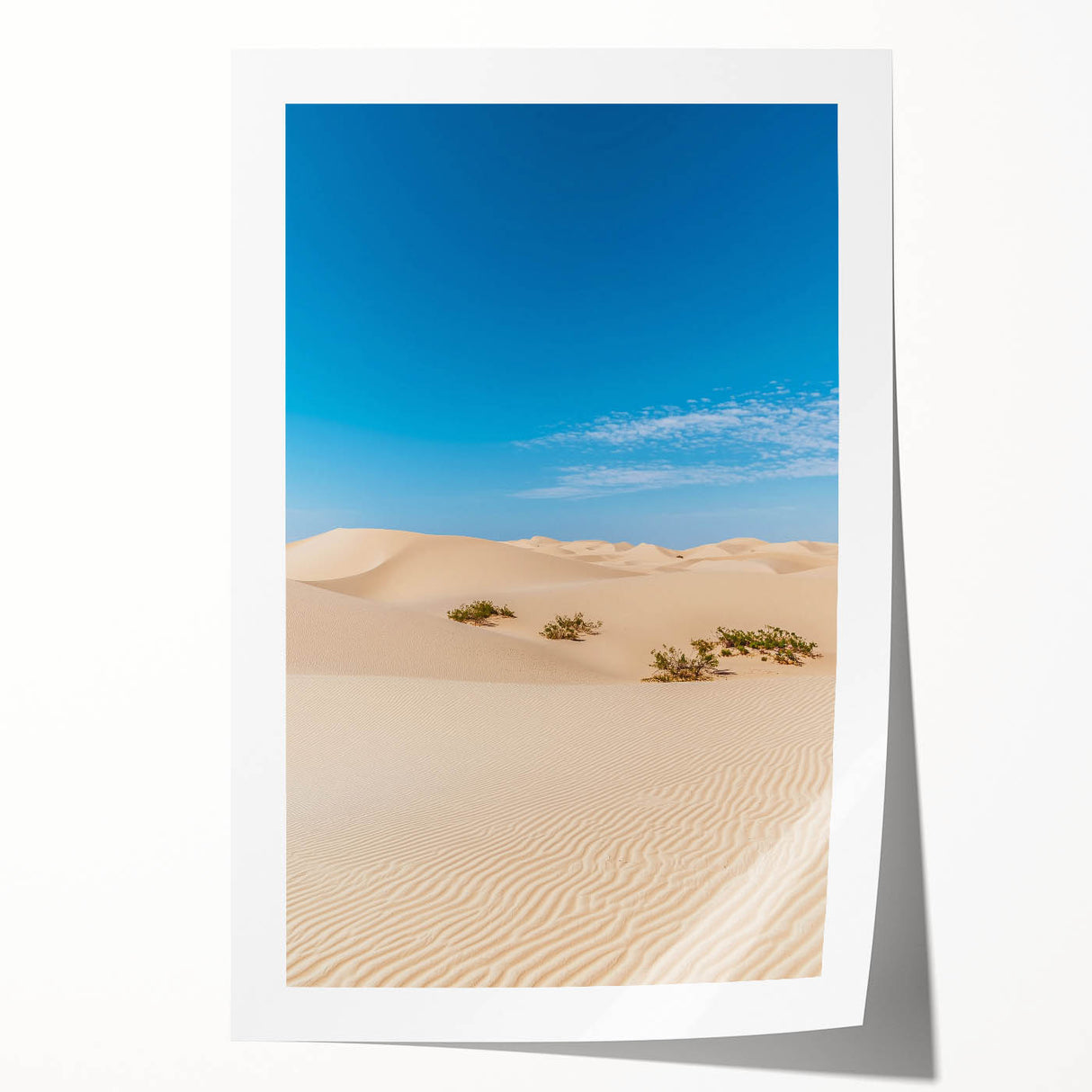 Desert landscape canvas print showcasing soft beige and golden dunes under a bright blue sky, elegantly rolled for easy transport and hanging. Perfect for home decor.