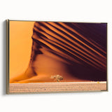 Framed canvas of a Namibian landscape featuring golden hues and black silhouettes, suitable for a living room.