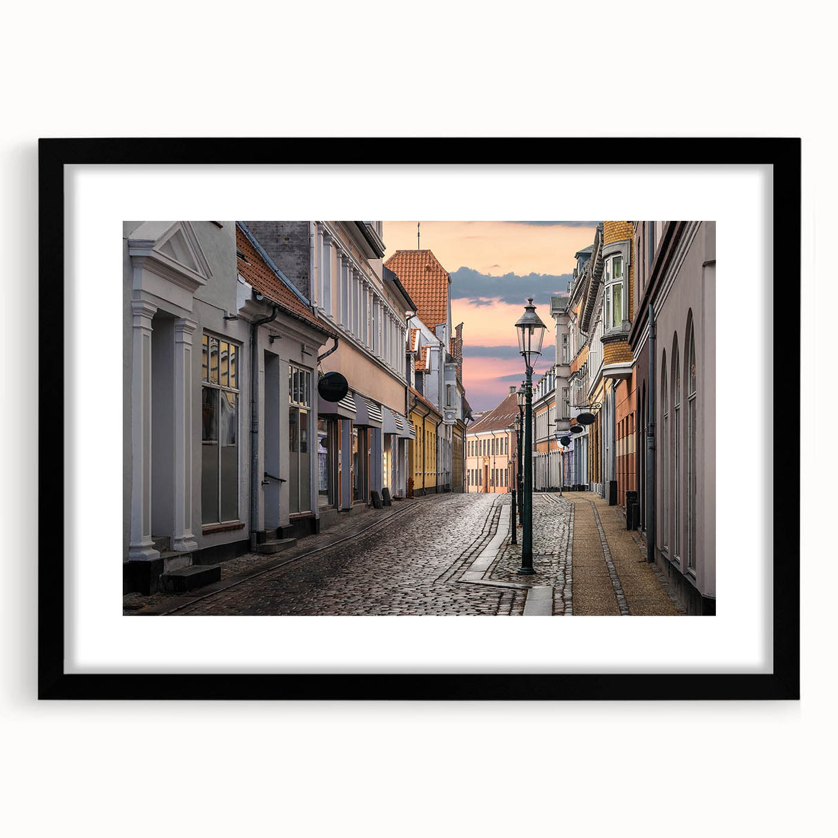 Abstract art print featuring vibrant, colorful textures of a European scenery, in a black frame with mat.