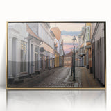 Art deco poster depicting a serene European landscape, in muted gold and blue tones, framed in acrylic.