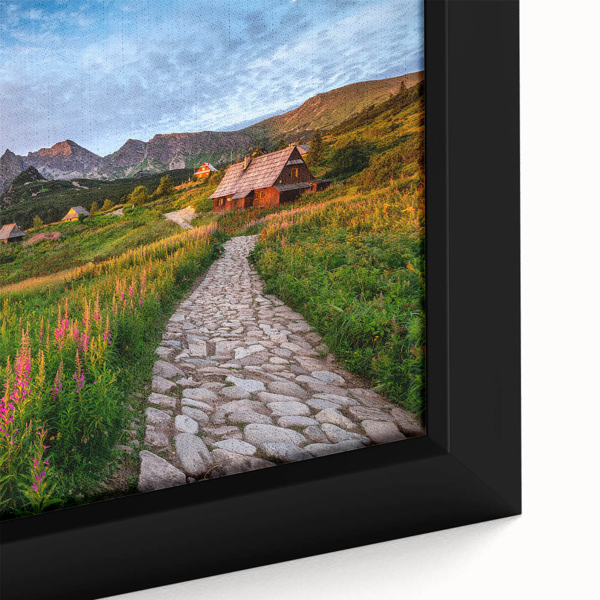 Close-up of a black framed canvas featuring a textured, colorful European scenery, ideal for living room decor.