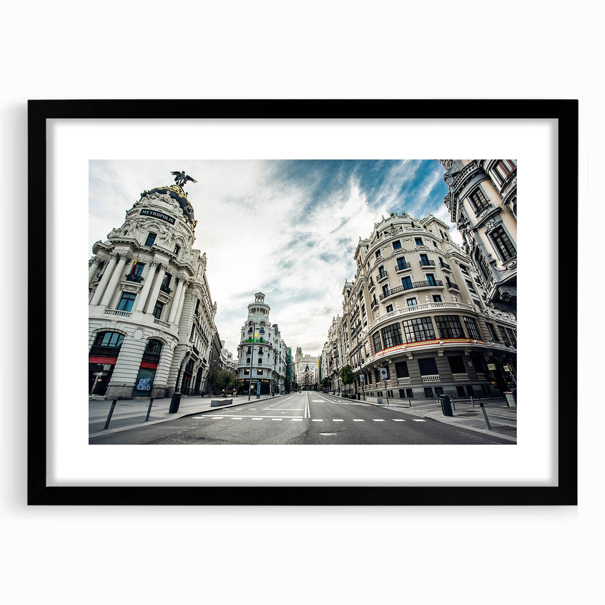 Extra large, colorful abstract art print of Madrid scenery in vibrant hues on a textured canvas, framed with black mat.