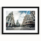 Extra large, colorful abstract art print of Madrid scenery in vibrant hues on a textured canvas, framed with black mat.
