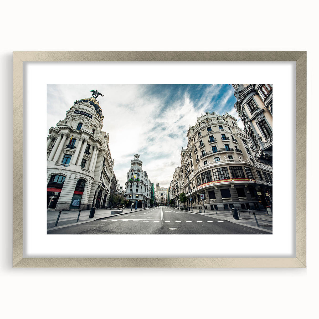 Textured art depicting an abstract Madrid cityscape in muted earth tones on a framed silver mat, suitable for bedroom decor.