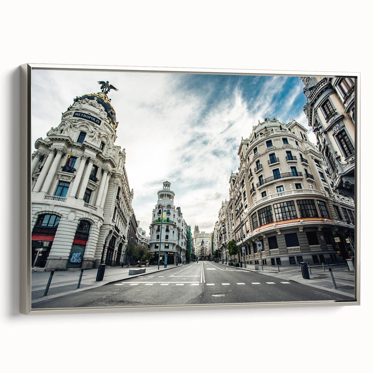 Landscape art painting of Madrid with colorful buildings and silhouetted trees on a framed canvas.