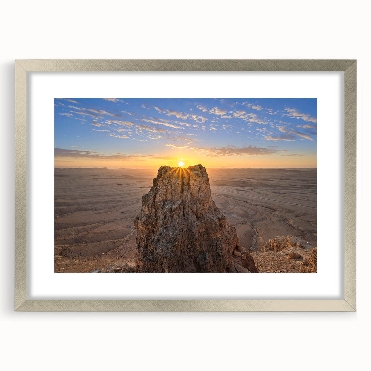 Textured art depicting an abstract Middle Eastern scenery in muted earth tones on a silver-framed mat.