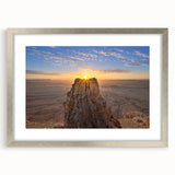 Textured art depicting an abstract Middle Eastern scenery in muted earth tones on a silver-framed mat.