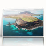 Acrylic print of a Galapagos scenery with lush greenery and blue waters, framed in white, suitable as modern art wall decor.