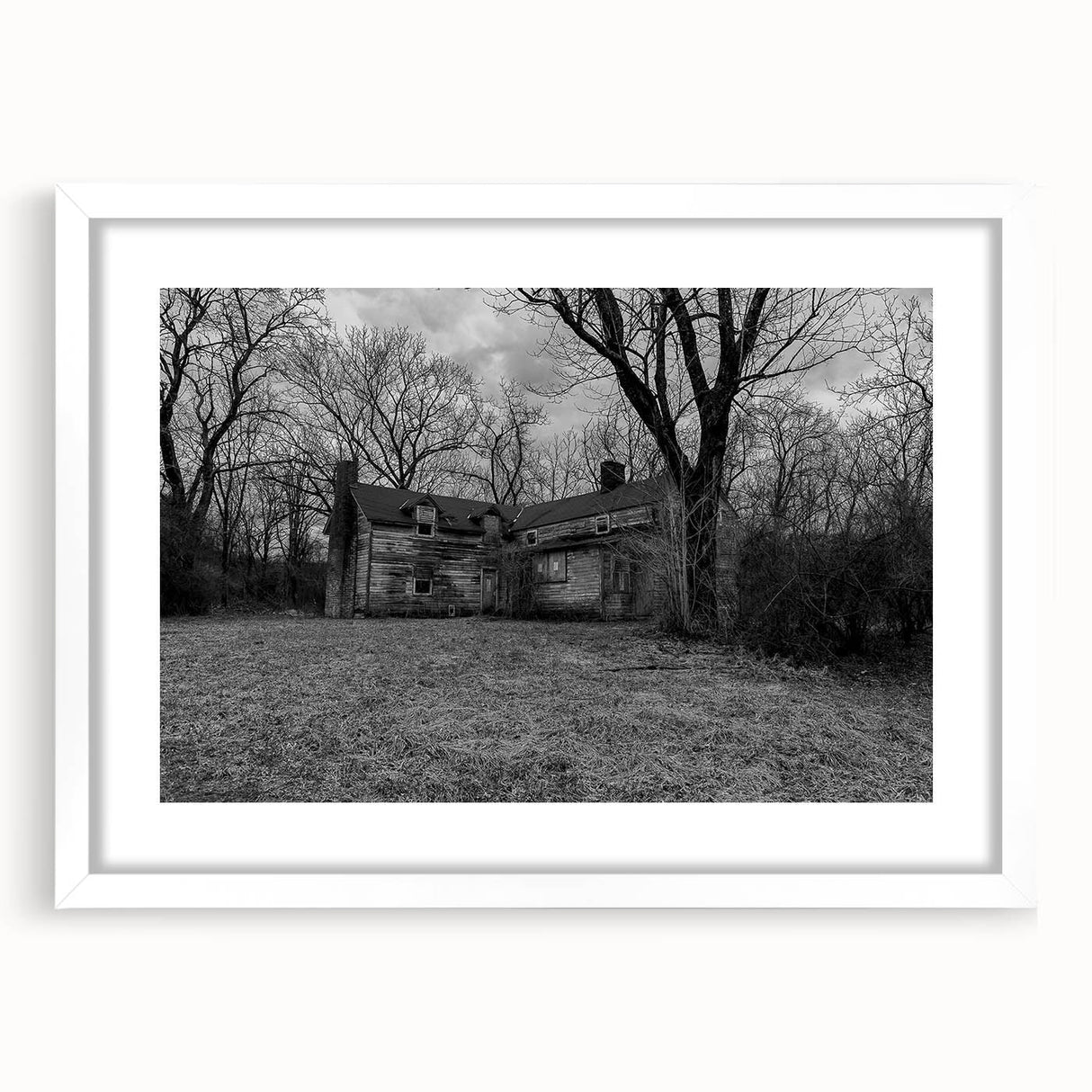 Abstract art print of Delaware scenery in muted blue and green tones on a framed white mat, suitable for dining room decor.