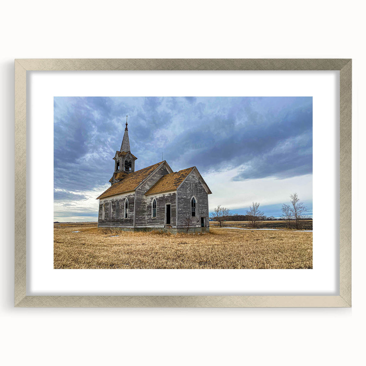 Textured abstract art print depicting Iowa scenery in muted earth tones, framed in silver, ideal for bedroom decor.