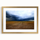 Extra large abstract art print featuring textured scenery of Kansas, in muted earth tones, framed in gold.