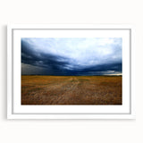 Abstract art print of Kansas scenery in muted earth tones on a white matted frame, ideal for dining room decor.