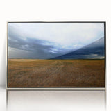 Mid-century modernist art depicting Kansas scenery in muted earth tones on a silver-framed acrylic print.