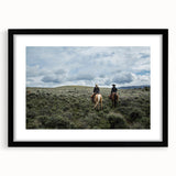 Colorful abstract art print of Montana scenery in vibrant hues on a large textured canvas, framed in black.