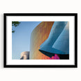 Abstract art print of Seattle skyline in colorful, textured hues on a large black-framed canvas, ideal for living room decor.