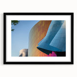 Abstract art print of Seattle skyline in colorful, textured hues on a large black-framed canvas, ideal for living room decor.