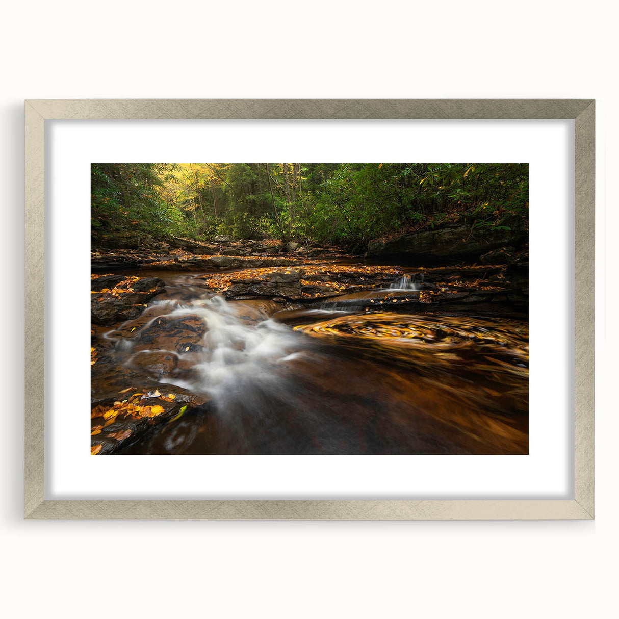 Textured art depicting abstract hills in muted green and blue tones on a silver-framed mat, ideal for bedroom decor.