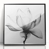 Framed acrylic artwork showcasing an abstract floral design with vibrant colors, set against a sleek black frame, perfect for modern home decor.