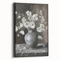 Framed canvas artwork showcasing abstract floral designs in vibrant hues of pink, blue, and green, featuring a sleek black frame for modern decor enhancement.