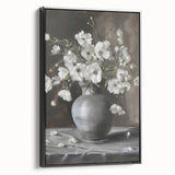 Framed canvas artwork showcasing abstract floral designs in vibrant hues of pink, blue, and green, featuring a sleek black frame for modern decor enhancement.