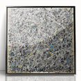 Framed acrylic artwork showcasing a vibrant abstract design with colorful splatters on a black background, perfect for modern home decor or art enthusiasts.
