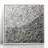 Framed acrylic artwork featuring vibrant abstract splatters in bold colors, set against a crisp white background, ideal for modern home decor.