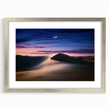Silver-framed landscape artwork showcasing serene sand dunes, accented with a white mat for an elegant presentation, ideal for modern home decor.