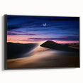 Framed canvas artwork depicting serene sand dunes at sunset, featuring soft beige and golden tones, with a sleek black frame enhancing its modern aesthetic. Perfect for adding a calming touch to any interior decor.