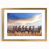 Extra large abstract art print of a Tanzanian scenery in muted earth tones on a textured canvas, framed in gold.