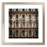 Textured abstract art print depicting a Middle Eastern scenery in muted earth tones on a silver-framed canvas.
