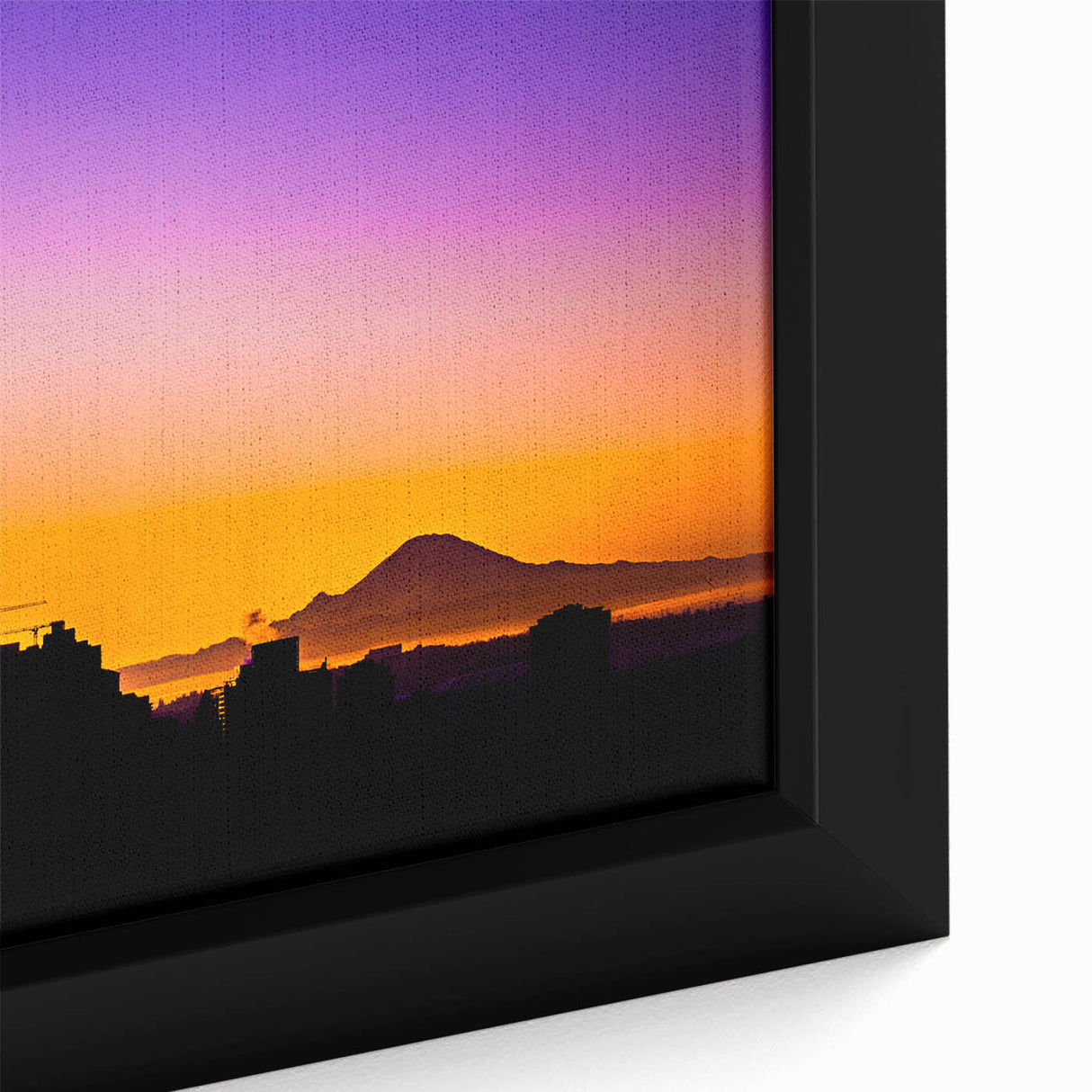 Close-up of black wall art featuring a textured Seattle skyline in colorful hues on a framed canvas.