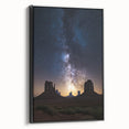 Framed canvas artwork showcasing a vibrant desert landscape with warm hues of orange and yellow, elegantly displayed with a sleek black frame, perfect for modern decor.