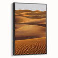 Framed canvas artwork showcasing a serene desert landscape with rolling dunes, presented in a sleek black frame, ideal for modern home decor. Perfect for enhancing interior aesthetics with a touch of nature's beauty.