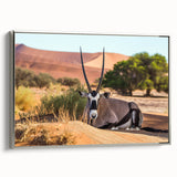 Vintage poster art of an African scenery in vibrant colors, framed in silver, ideal for living room decor.