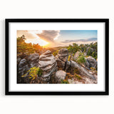 Textured art depicting an abstract European cityscape in muted earth tones on a framed black mat.