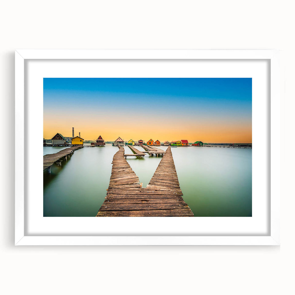 Textured abstract art print of a European scenery in muted earth tones, framed with a white mat, suitable for bedroom decor.