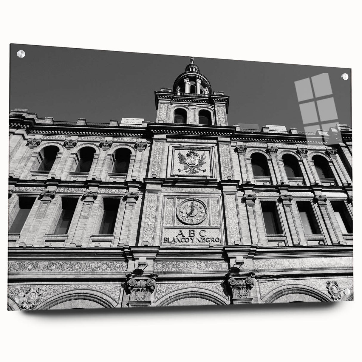 Large abstract depiction of Madrid in muted orange and blue shades on acrylic glass.
