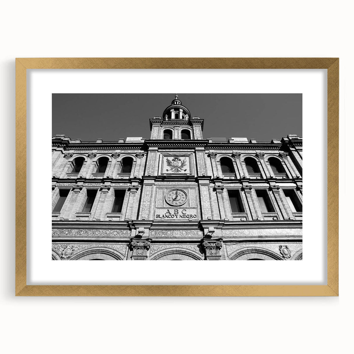 Extra large abstract art print of Madrid's skyline in textured gold tones on a framed canvas, ideal for living room decor.