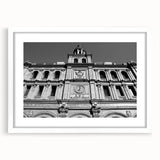 Abstract art print of Madrid skyline in muted blue and orange tones on a framed white mat, ideal for dining room decor.