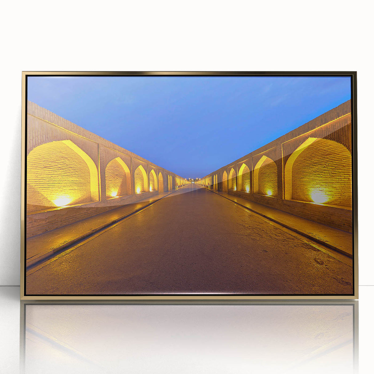 Large art print of a Middle Eastern landscape in gold and earth tones on acrylic, framed, in mid-century modernist style.