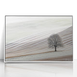 Framed acrylic artwork depicting an abstract landscape with soft pastel colors of blue, pink, and white, ideal for modern home decor. Perfect for adding a serene touch to living spaces.