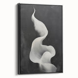 Framed minimalist wall art featuring an abstract black design on canvas, showcasing a sleek side view that highlights its modern aesthetic, perfect for contemporary decor.