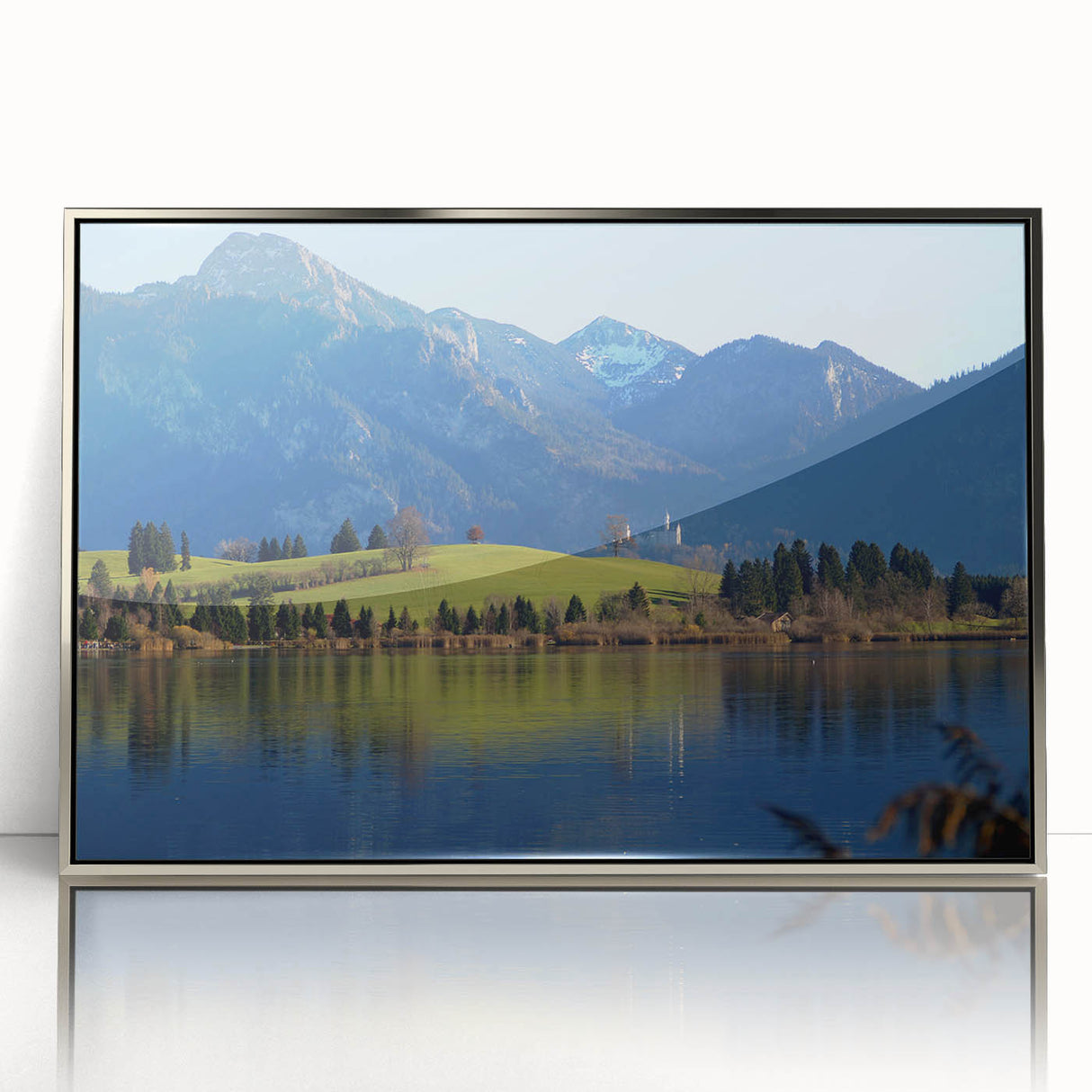 Acrylic print of a Bavarian landscape in muted green and blue tones, framed in silver, suitable for modern art wall decor.