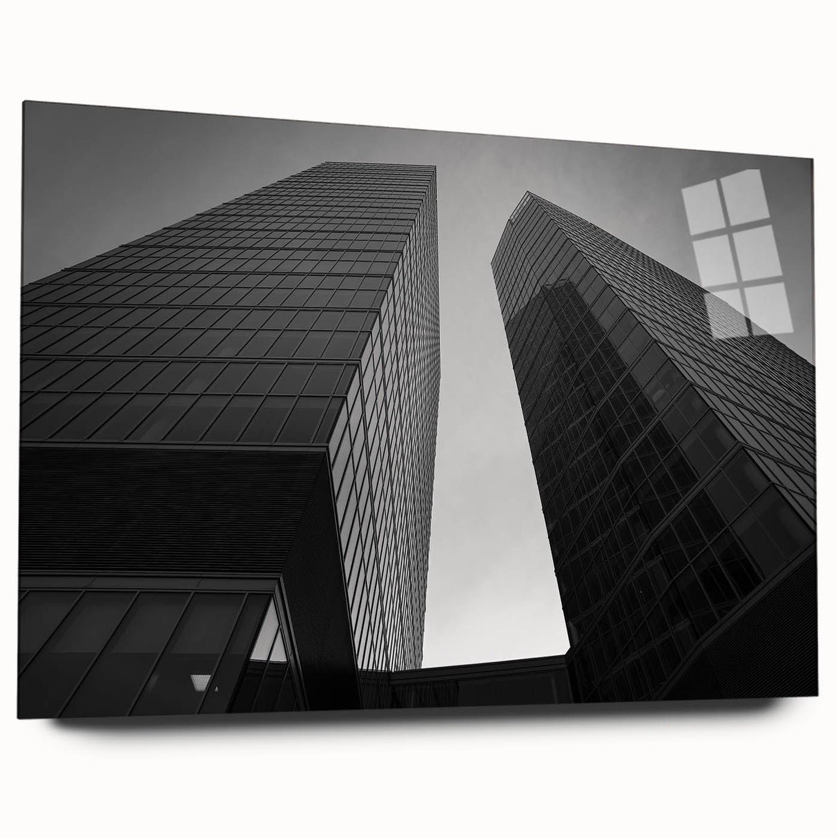 Large abstract wall art of a European cityscape in muted gray and blue tones on acrylic glass.
