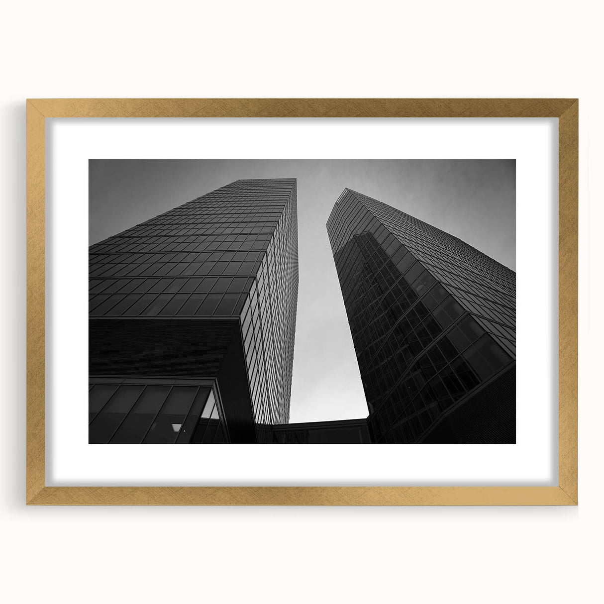 Abstract art print of a European scenery in muted gold and green tones, framed with a gold mat.