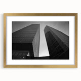 Abstract art print of a European scenery in muted gold and green tones, framed with a gold mat.