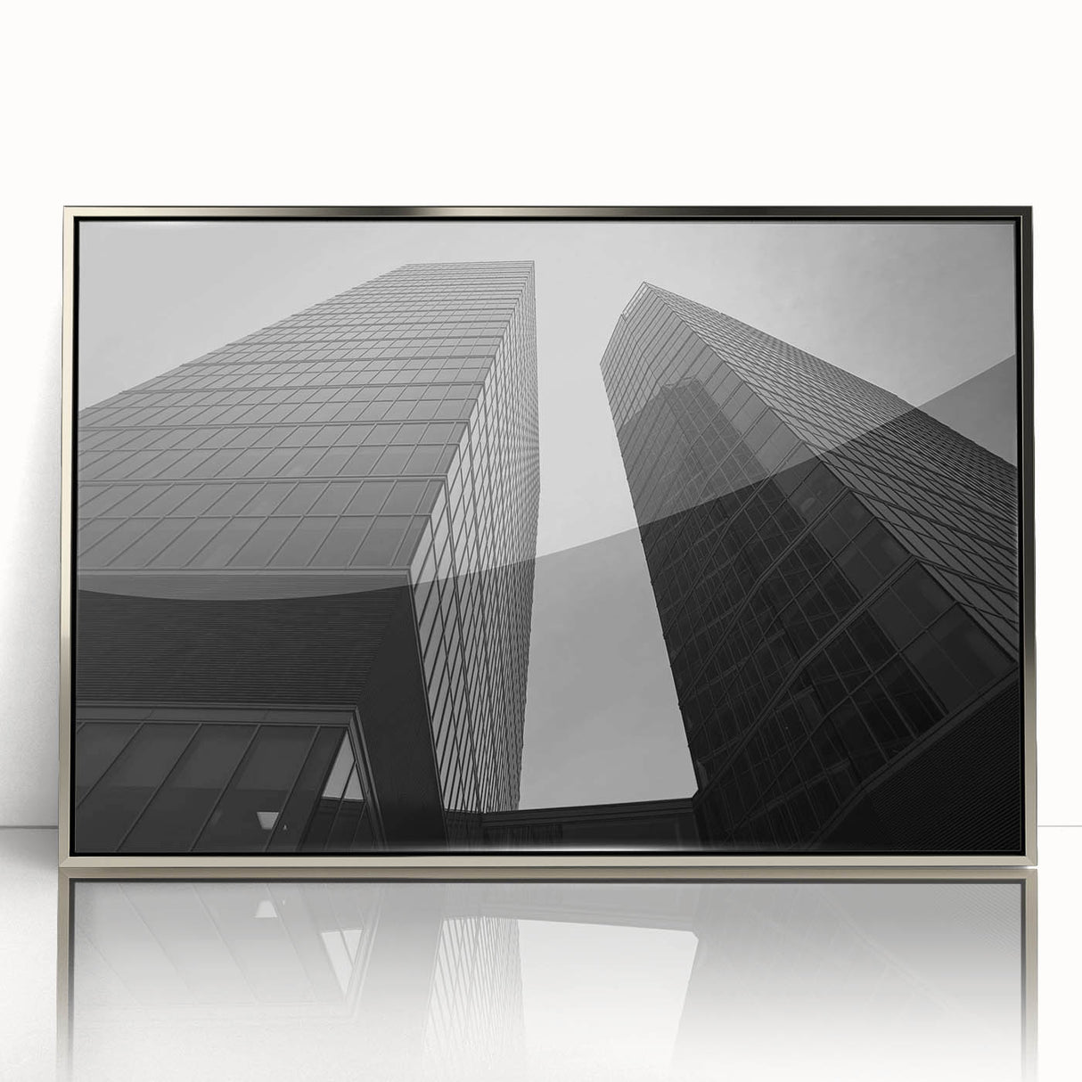 Large art print of a European cityscape in muted gray and blue tones, framed in silver acrylic.