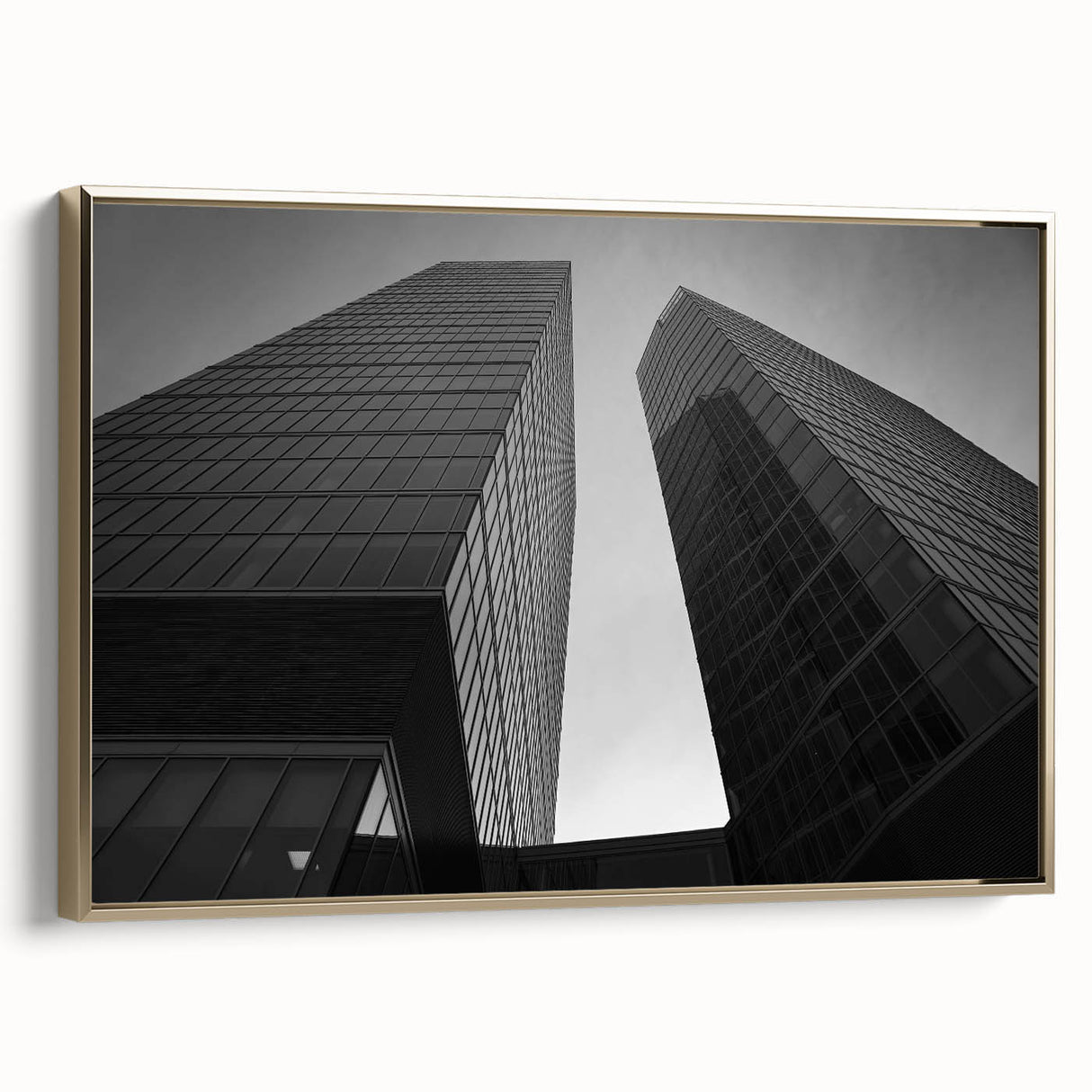 Framed canvas featuring a vintage-style landscape painting of a European scene in black and gold tones.